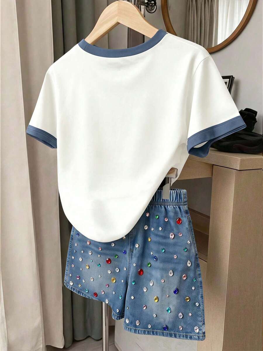 Girls' multicolor short sleeve T-shirt and shorts set featuring a cute cherry and bow print with round neck top and matching shorts.