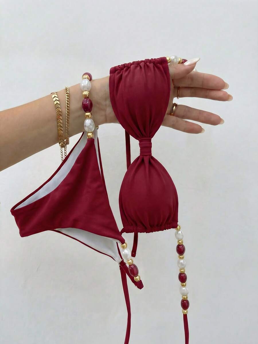 Women's green halter neck bikini set featuring color-block beaded shoulder straps, back tie detail, and high cut bottoms.