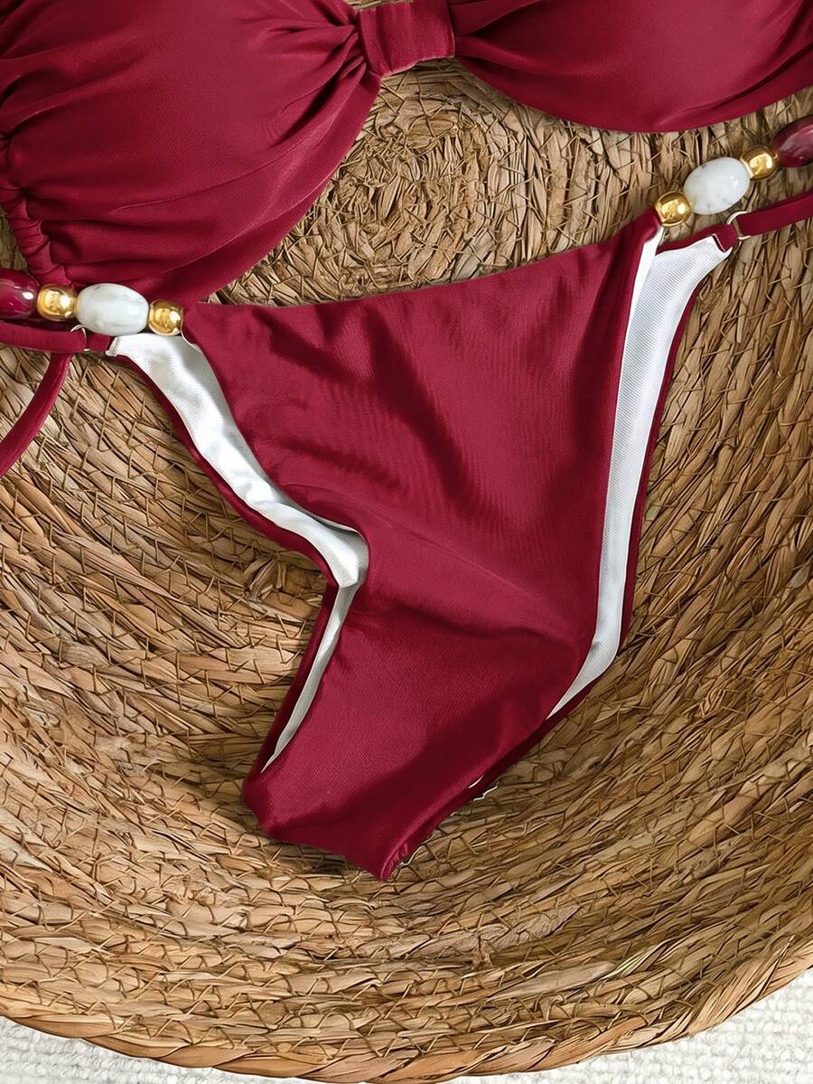 Women's green halter neck bikini set featuring color-block beaded shoulder straps, back tie detail, and high cut bottoms.