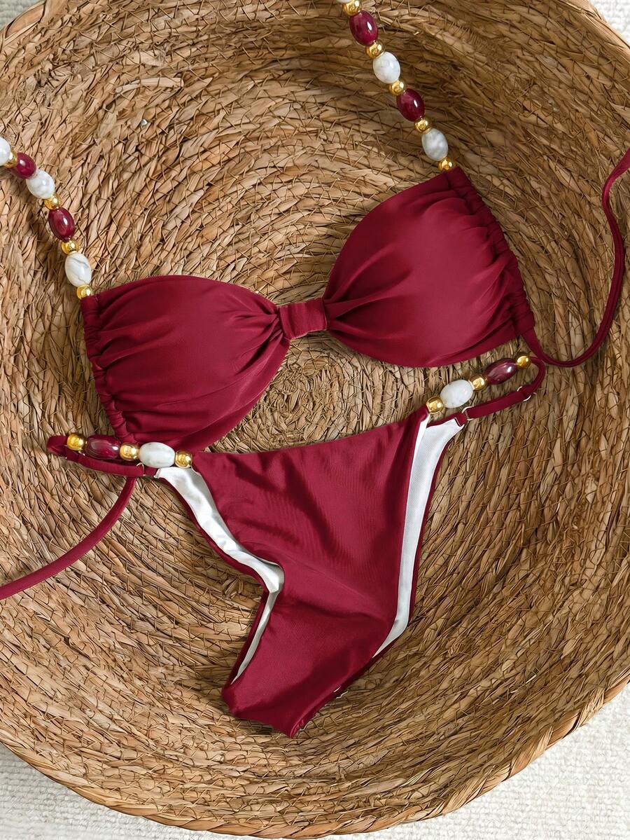 Women's green halter neck bikini set featuring color-block beaded shoulder straps, back tie detail, and high cut bottoms.