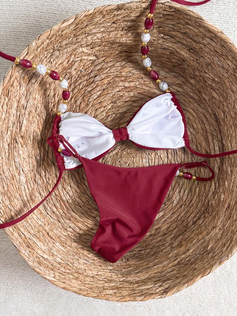 Women's green halter neck bikini set featuring color-block beaded shoulder straps, back tie detail, and high cut bottoms.