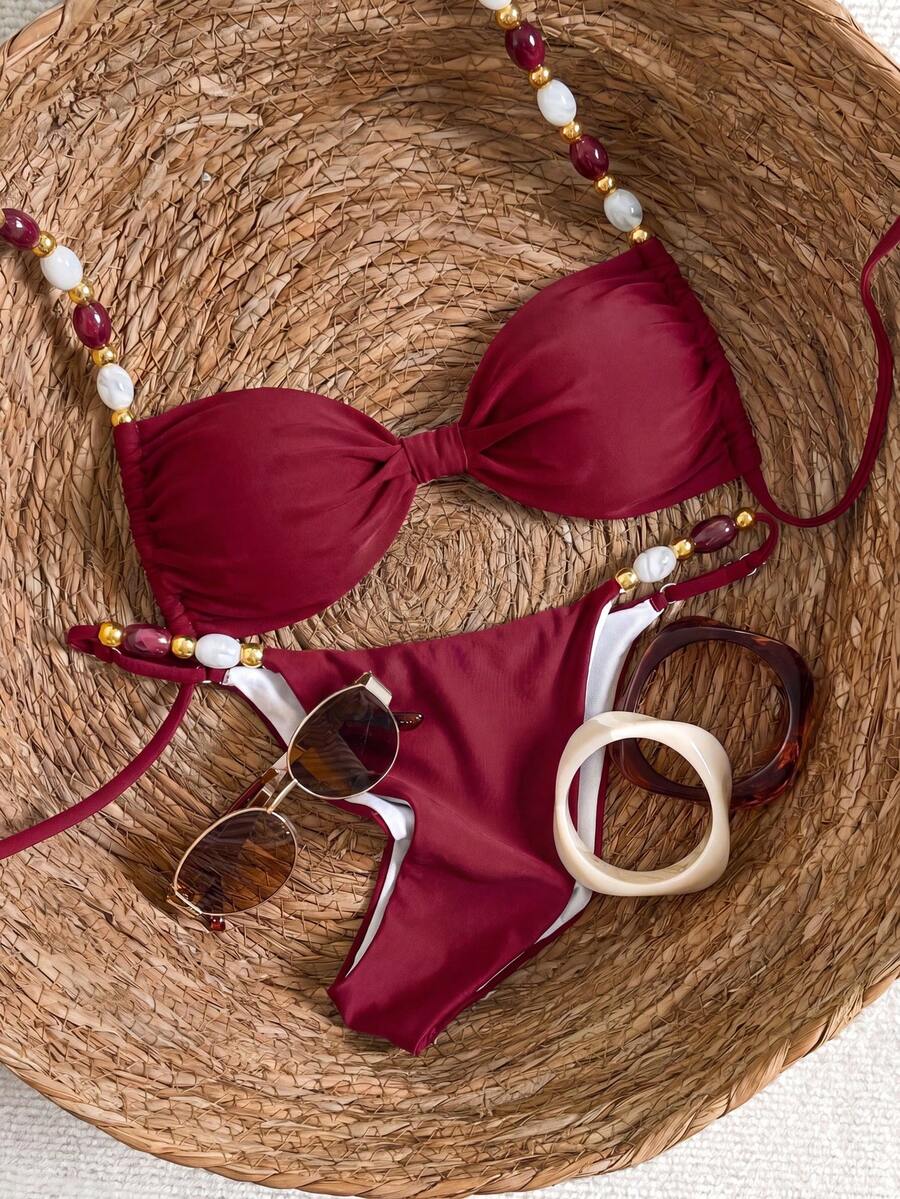 Women's green halter neck bikini set featuring color-block beaded shoulder straps, back tie detail, and high cut bottoms.