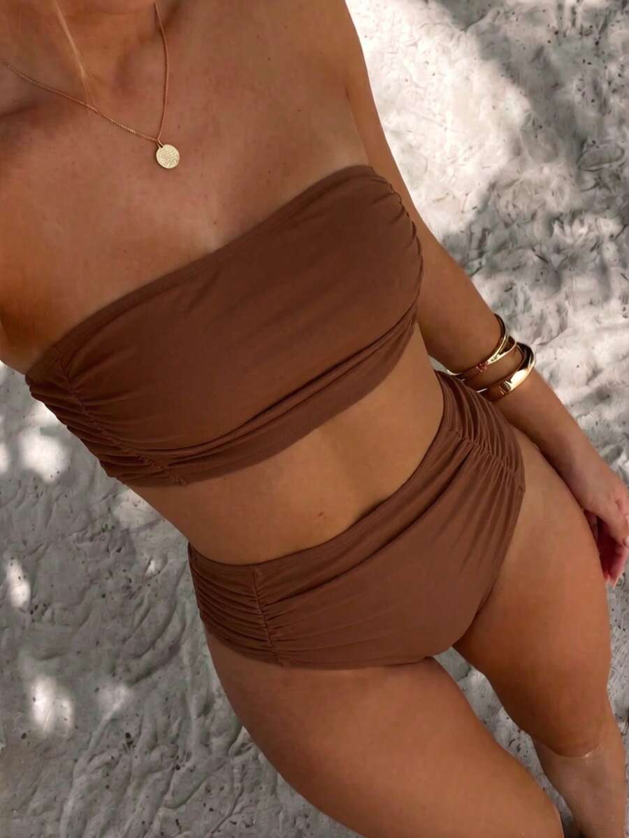 Women's black strapless ruched bandeau bikini top with high waisted bottoms