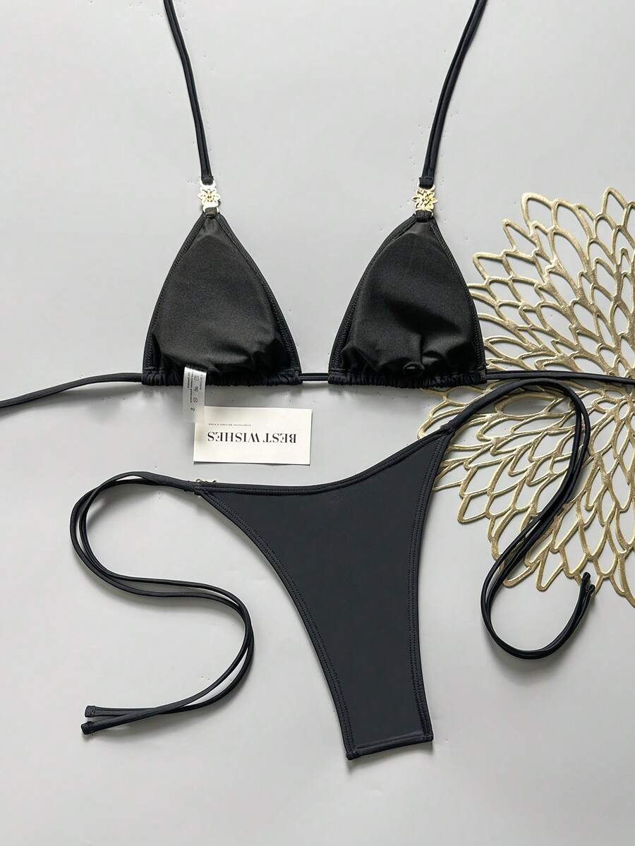 Women's black halter bikini set featuring triangle cups with gold bead decor and tie-back closure