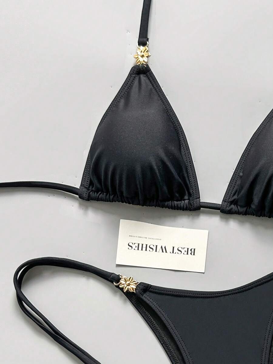 Women's black halter bikini set featuring triangle cups with gold bead decor and tie-back closure