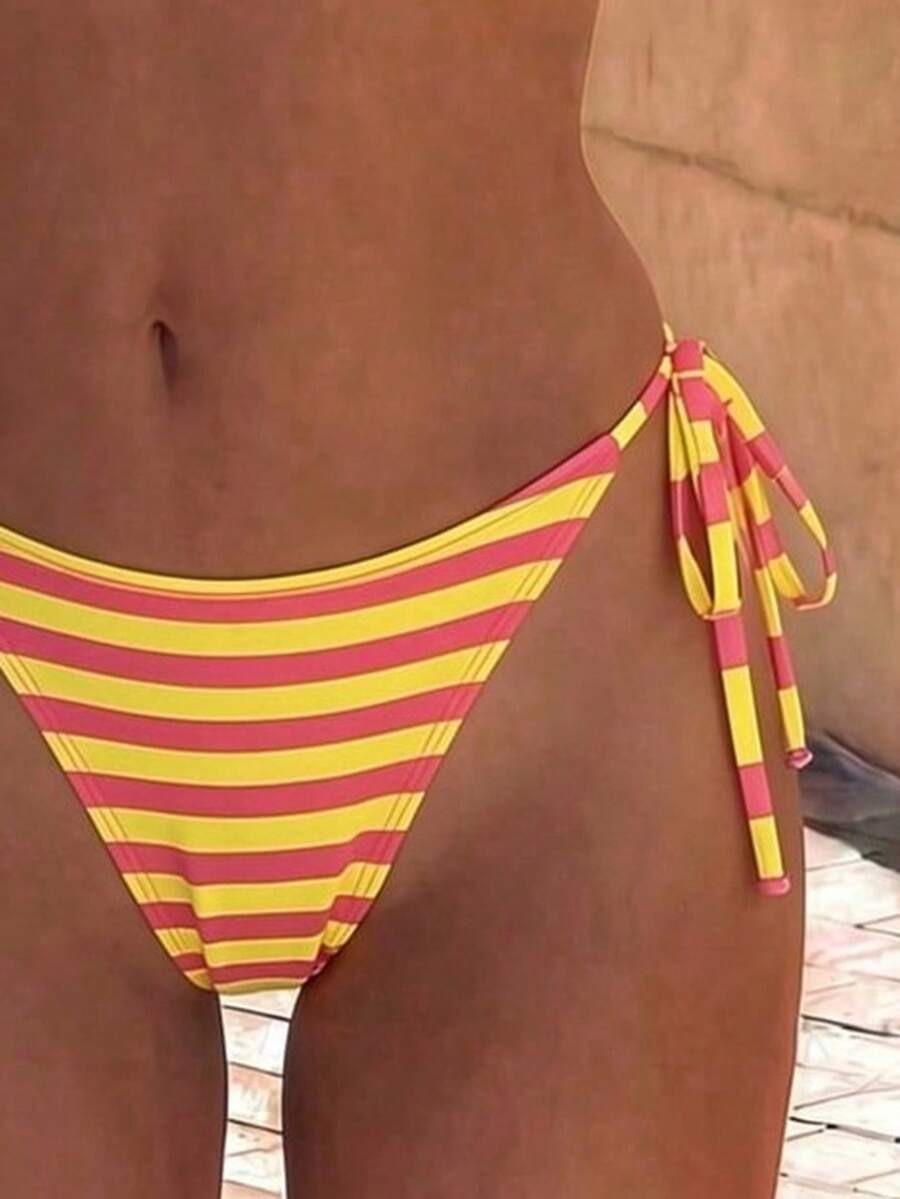 Women's black two-piece bikini set featuring a halter neck with a colorful sun pendant, triangle cups, and high-cut tie-side bottoms.