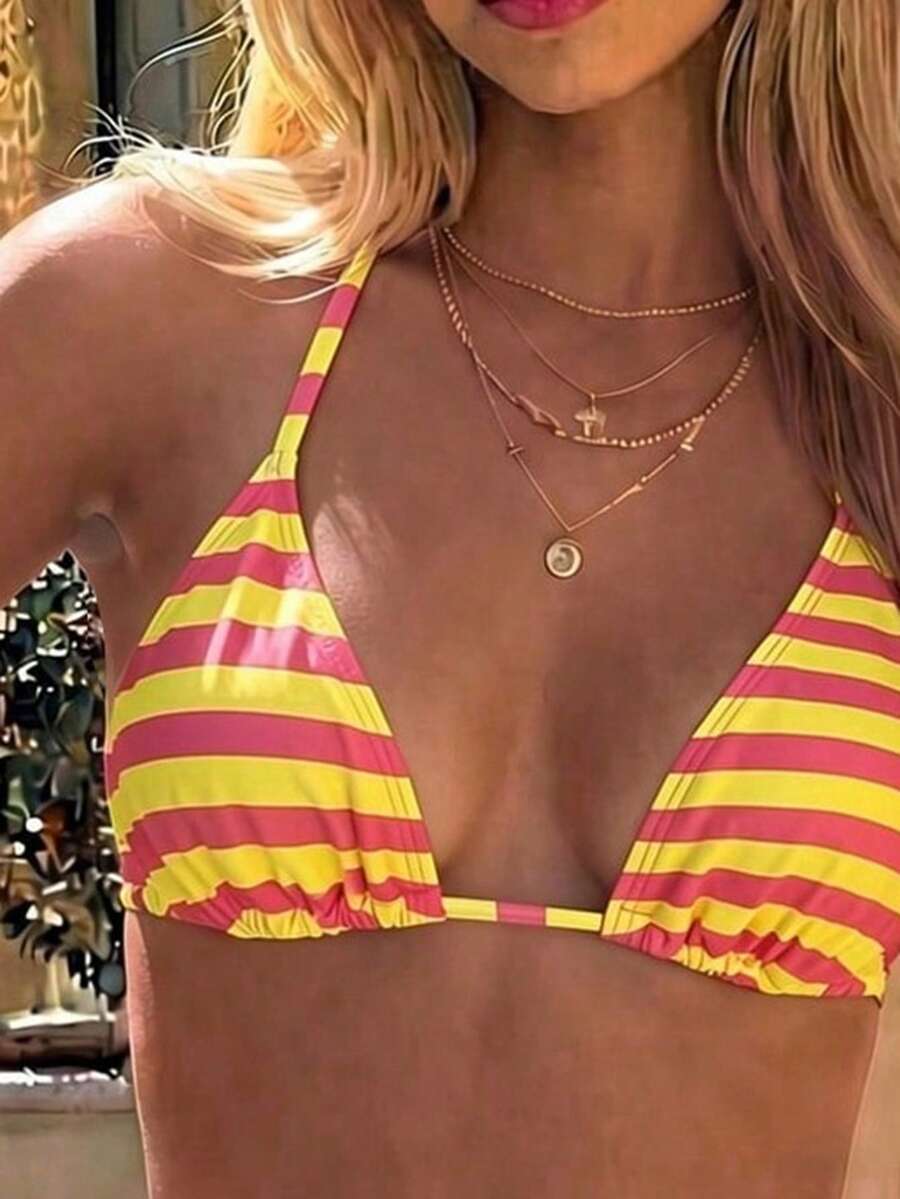Women's black two-piece bikini set featuring a halter neck with a colorful sun pendant, triangle cups, and high-cut tie-side bottoms.