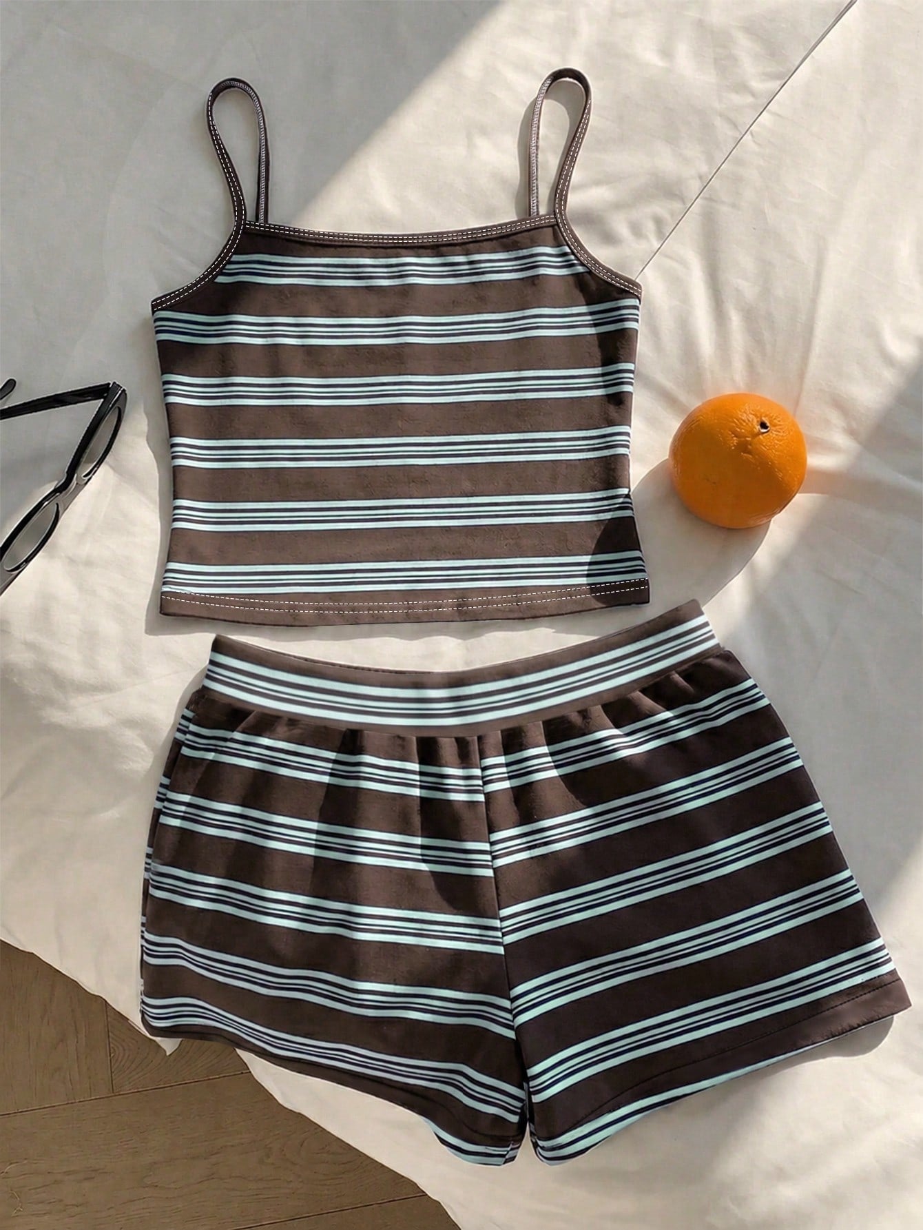 Tween girls summer 2-piece Hawaiian style outfit featuring a graphic print spaghetti strap camisole top with contrast piping and matching casual shorts.