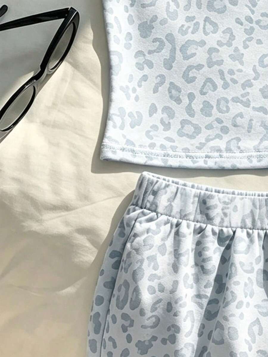 Tween girls summer 2-piece Hawaiian style outfit featuring a graphic print spaghetti strap camisole top with contrast piping and matching casual shorts.