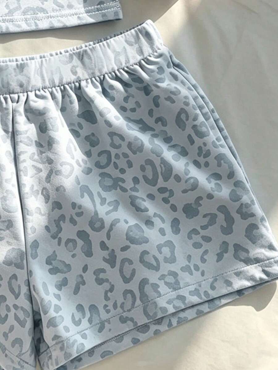 Tween girls summer 2-piece Hawaiian style outfit featuring a graphic print spaghetti strap camisole top with contrast piping and matching casual shorts.