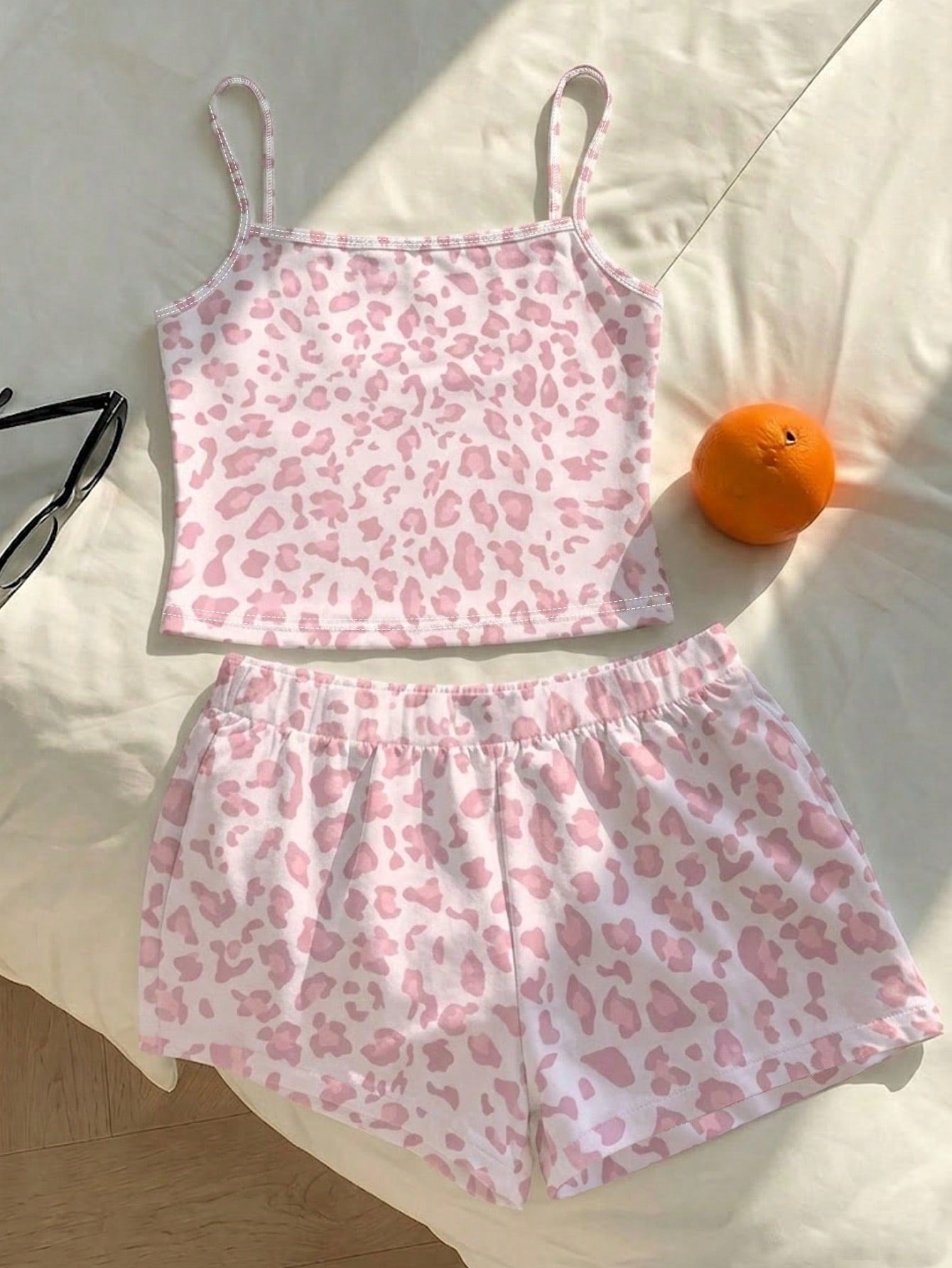 Tween girls summer 2-piece Hawaiian style outfit featuring a graphic print spaghetti strap camisole top with contrast piping and matching casual shorts.