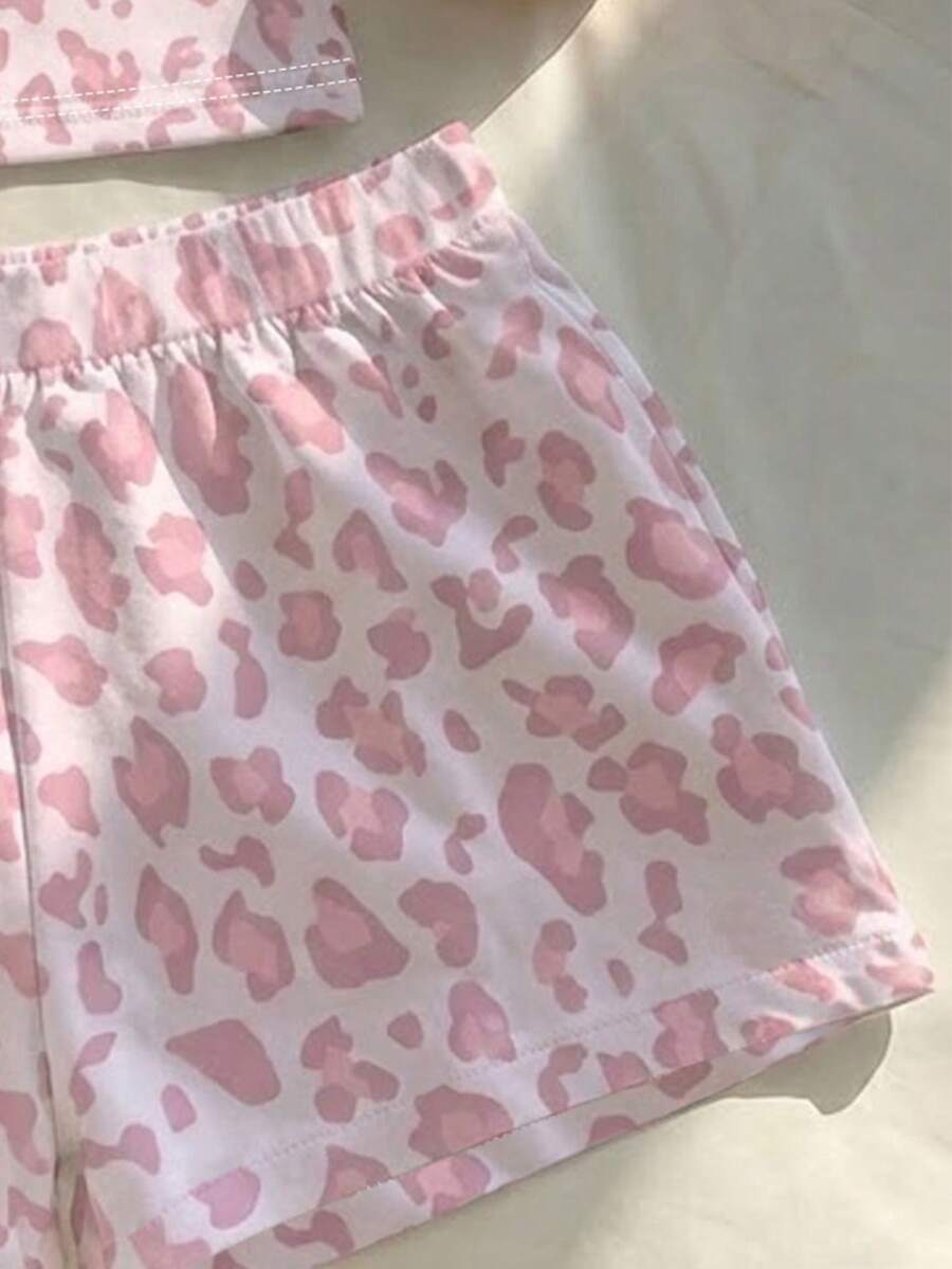 Tween girls summer 2-piece Hawaiian style outfit featuring a graphic print spaghetti strap camisole top with contrast piping and matching casual shorts.