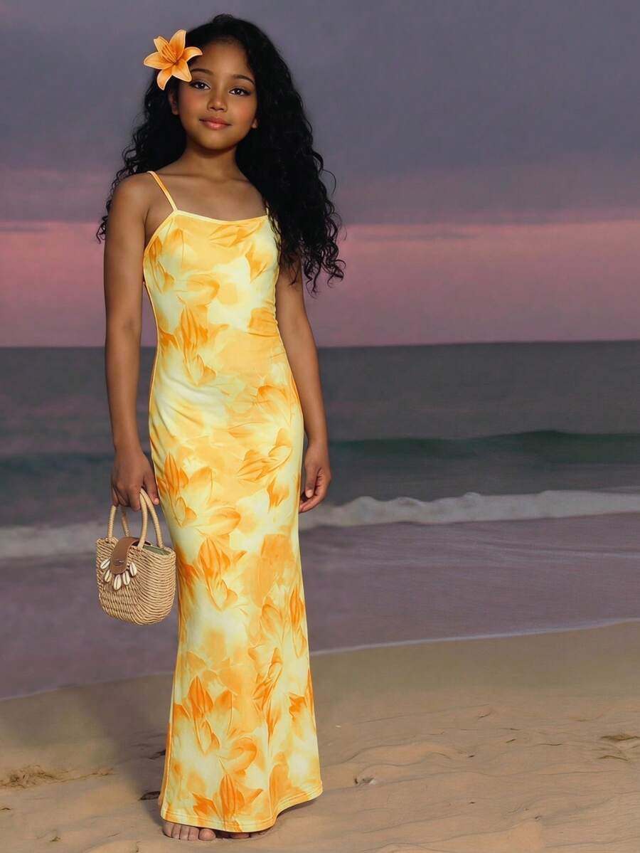 Tween girls black cami midi dress featuring plant print, spaghetti straps, slim fit, and a flared hem.