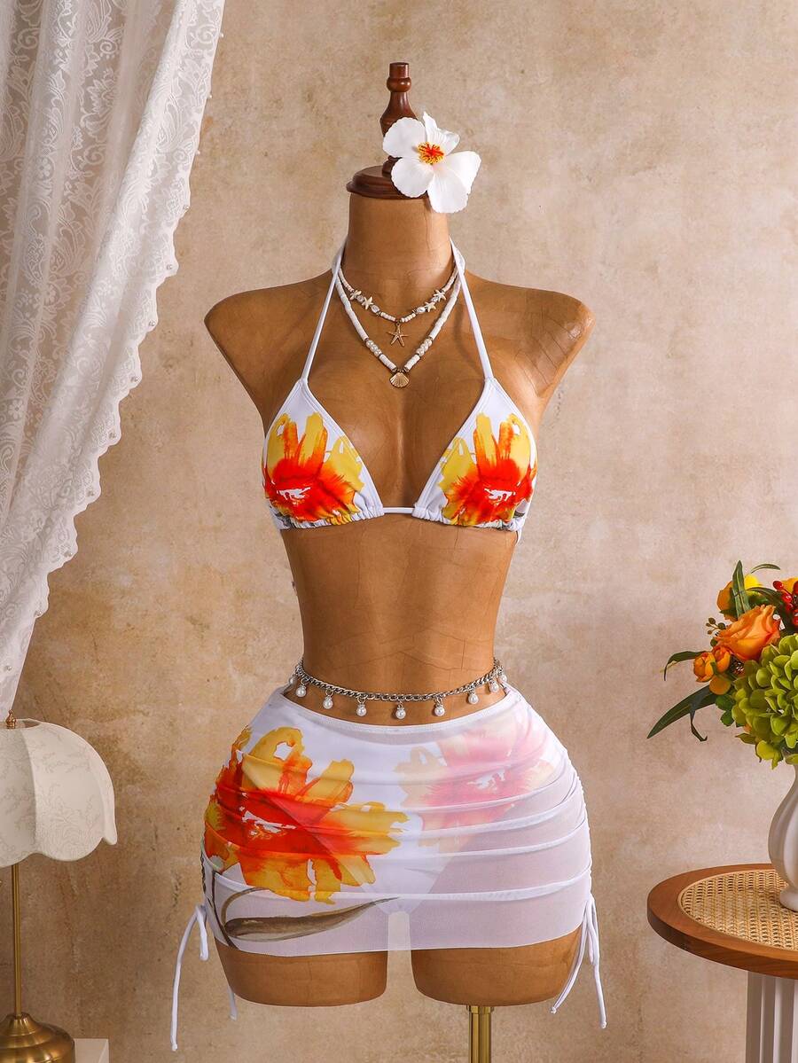 Women's black 3-piece bikini set featuring a halter triangle top with removable padding, high-waisted bottoms, and a knee-length mesh skirt with tie details.