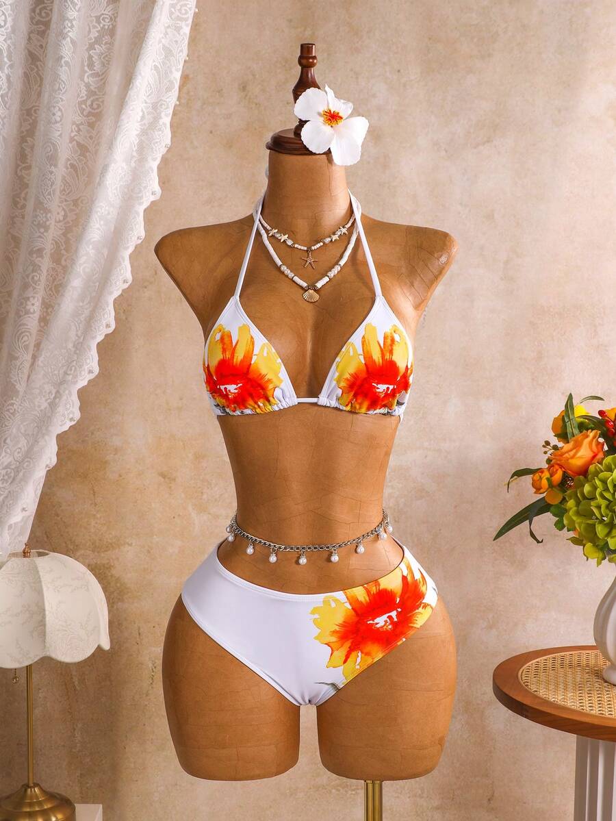 Women's black 3-piece bikini set featuring a halter triangle top with removable padding, high-waisted bottoms, and a knee-length mesh skirt with tie details.