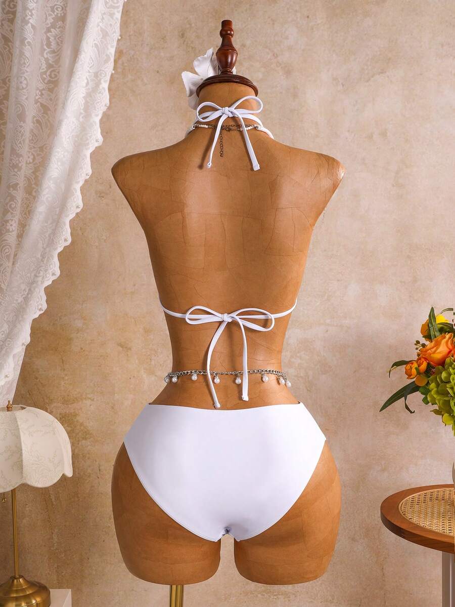 Women's black 3-piece bikini set featuring a halter triangle top with removable padding, high-waisted bottoms, and a knee-length mesh skirt with tie details.