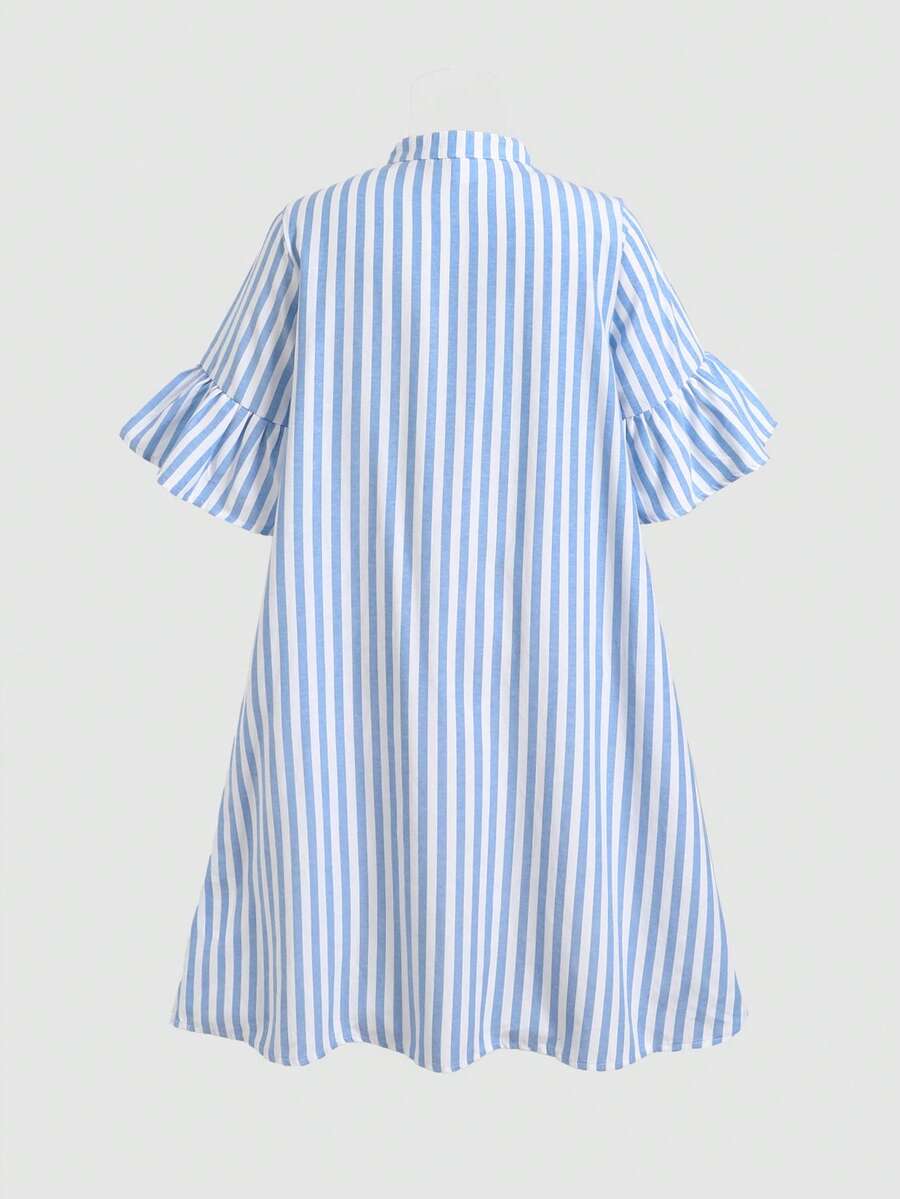 Tween girl wearing a black striped smock shirt dress with flounce half sleeves, a stand collar, and a ruffled hem.