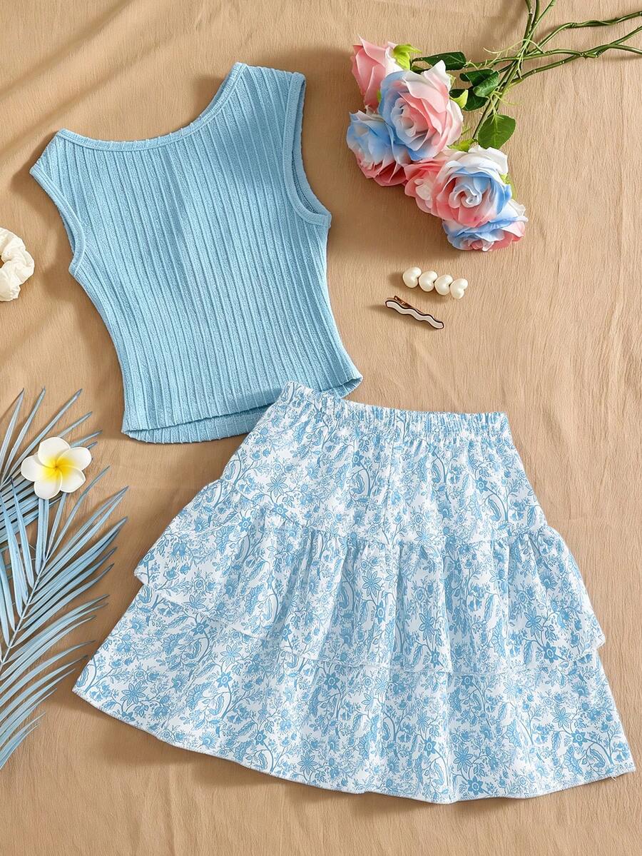 Light blue two-piece outfit set for tween girls with a sleeveless round neck vest top and a tiered ruffle cake skirt featuring a plant pattern.