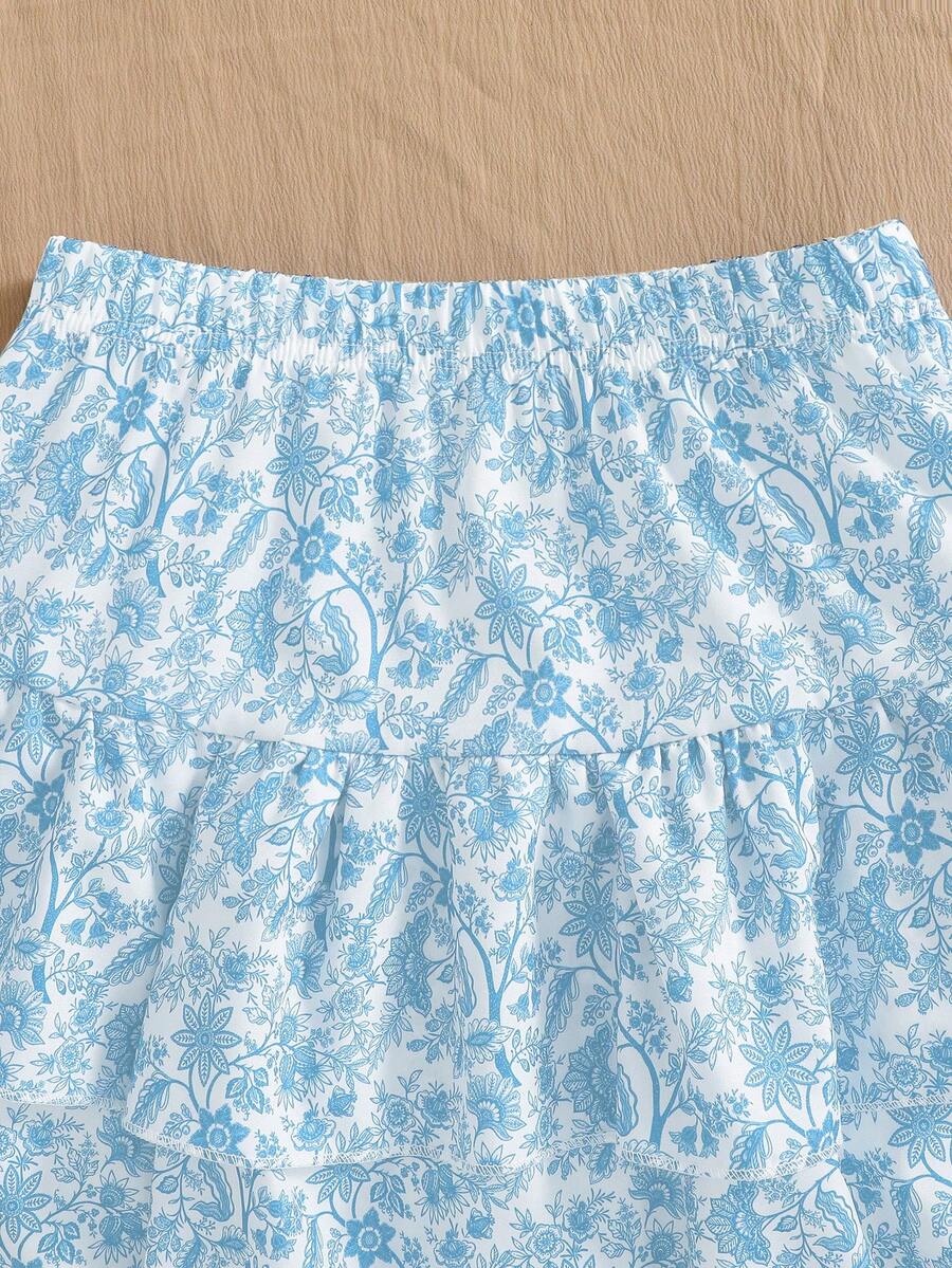 Light blue two-piece outfit set for tween girls with a sleeveless round neck vest top and a tiered ruffle cake skirt featuring a plant pattern.