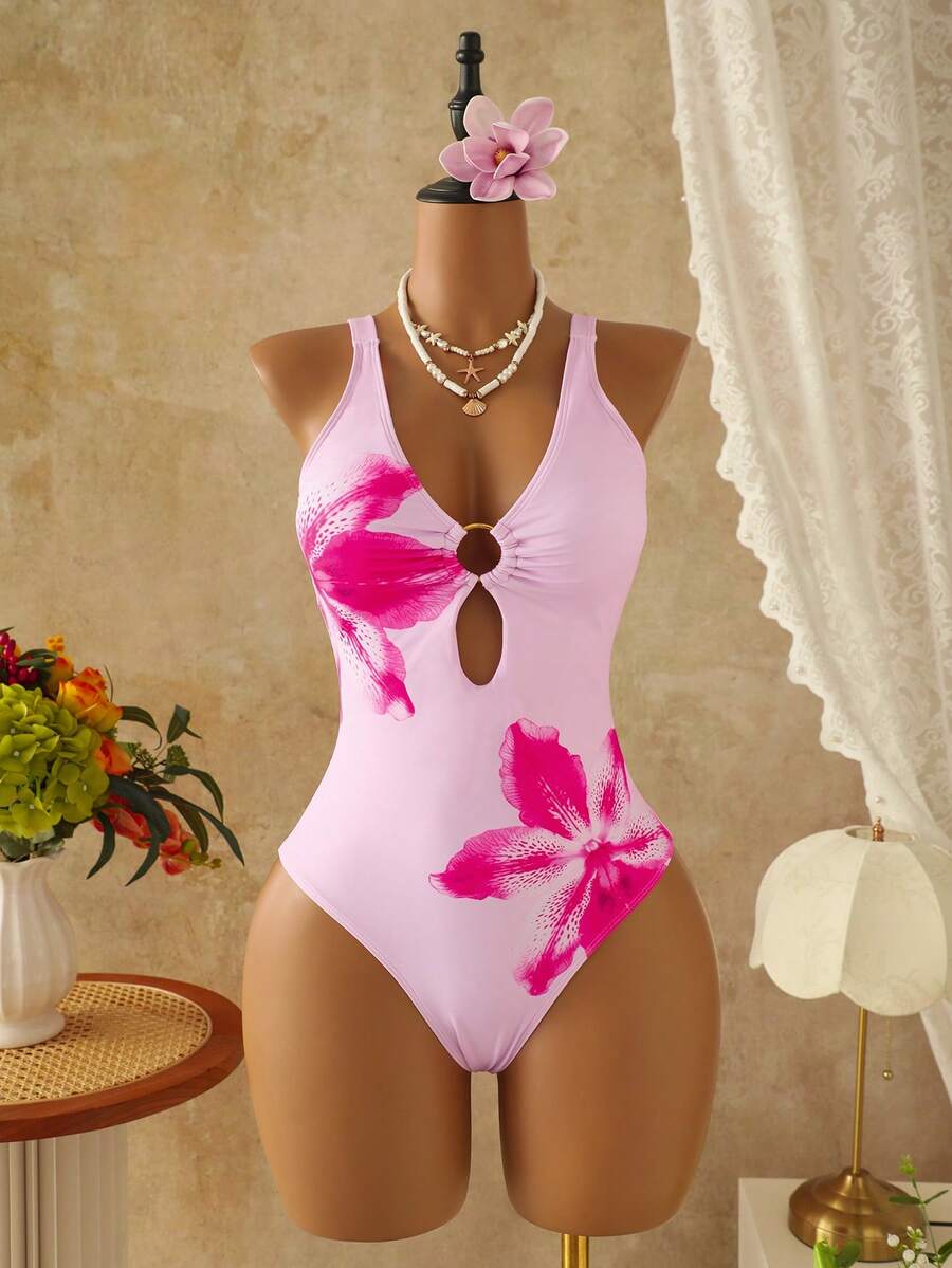 Women's black floral print plunge neck one-piece swimsuit featuring cut-out detail paired with a matching knee-length mesh cover-up skirt
