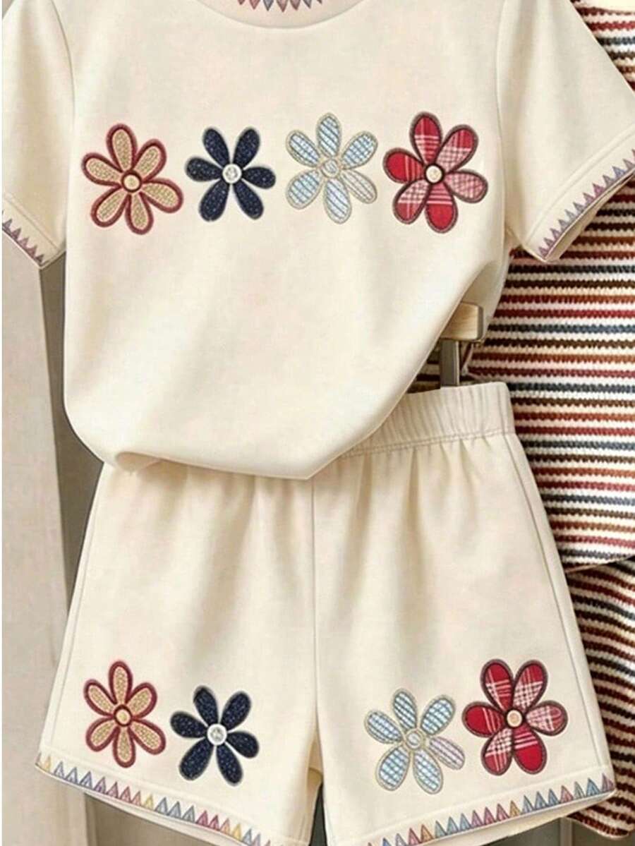 Girls' multicolor short sleeve T-shirt and shorts set featuring a cute cherry and bow print with round neck top and matching shorts.