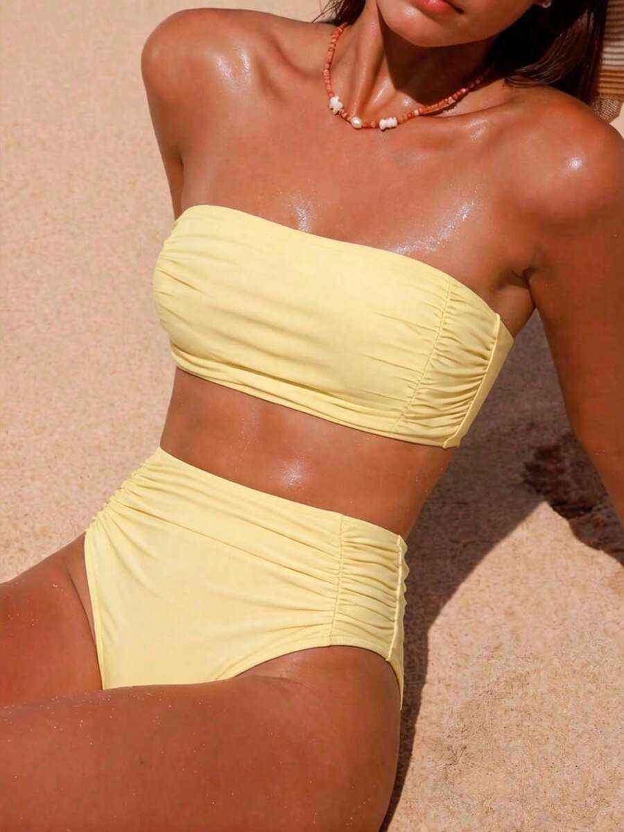 Women's black strapless ruched bandeau bikini top with high waisted bottoms