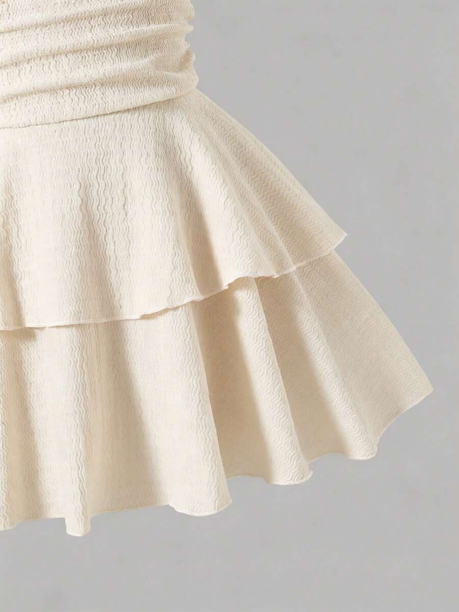 Tween girls apricot sleeveless halter mini dress with textured starfish and shell decor, shirred tiered layer, high waist, and flounce hem.