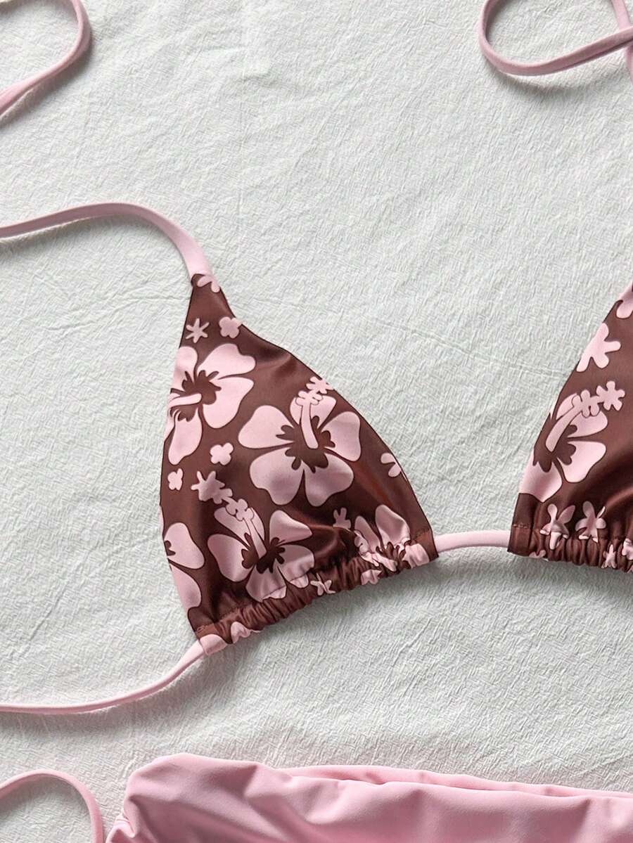 Women's halter triangle bikini top with knot detail paired with mid-waist colorblock swim shorts.