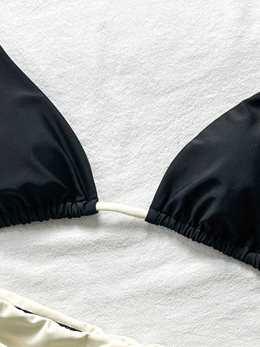 Women's halter triangle bikini top with knot detail paired with mid-waist colorblock swim shorts.