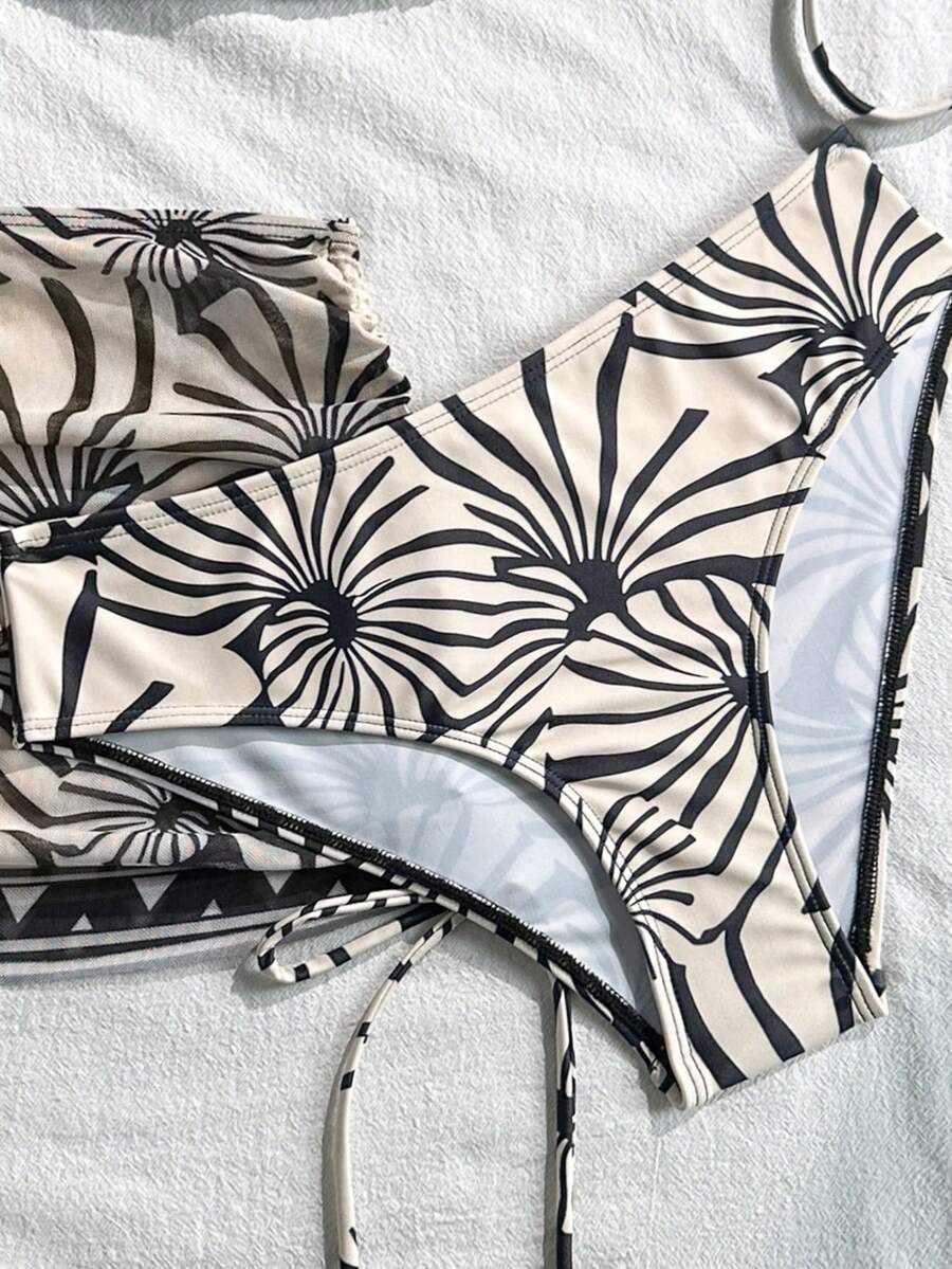 Women's black 3-piece bikini set featuring a halter triangle top with removable padding, high-waisted bottoms, and a knee-length mesh skirt with tie details.