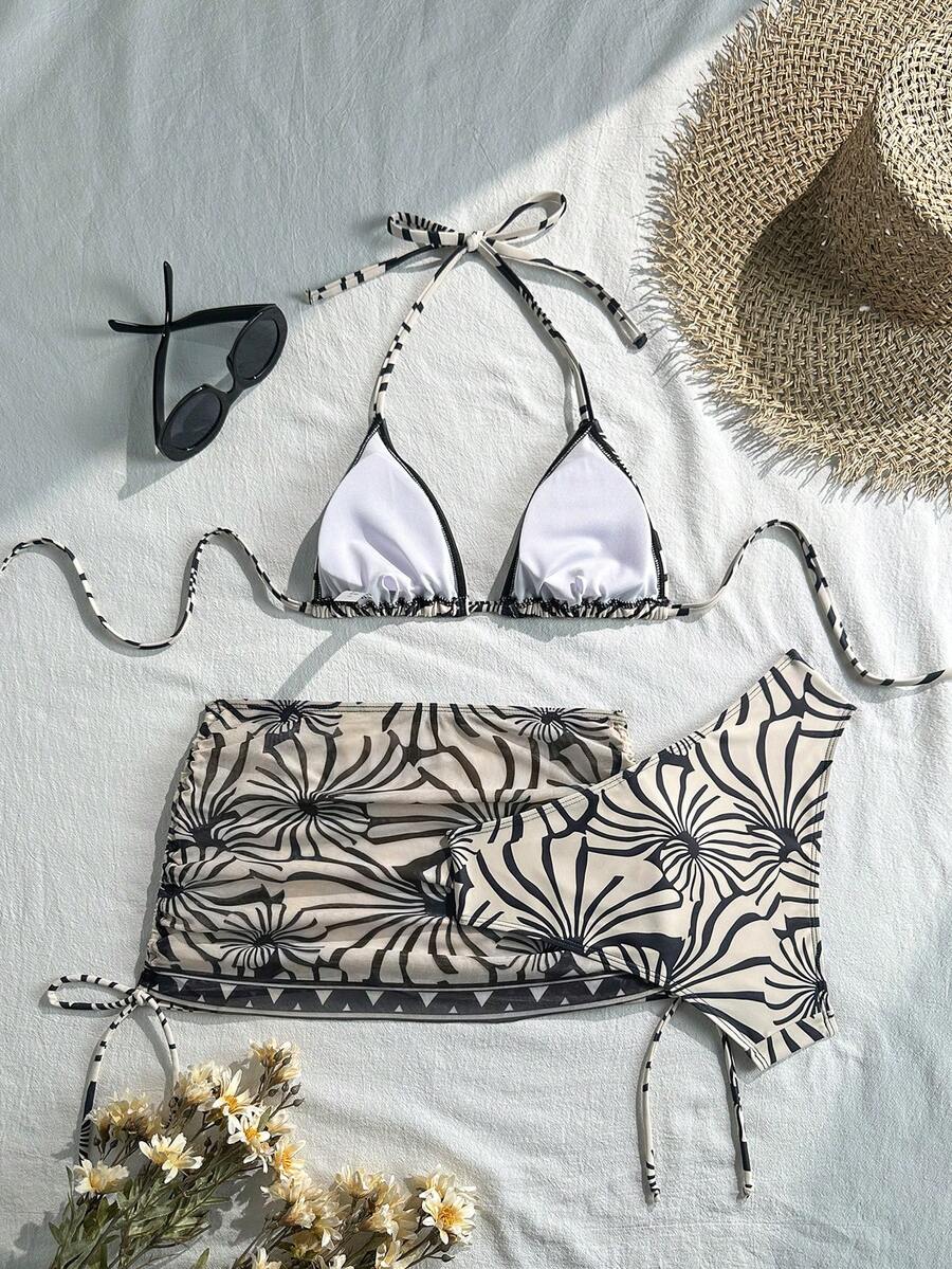Women's black 3-piece bikini set featuring a halter triangle top with removable padding, high-waisted bottoms, and a knee-length mesh skirt with tie details.