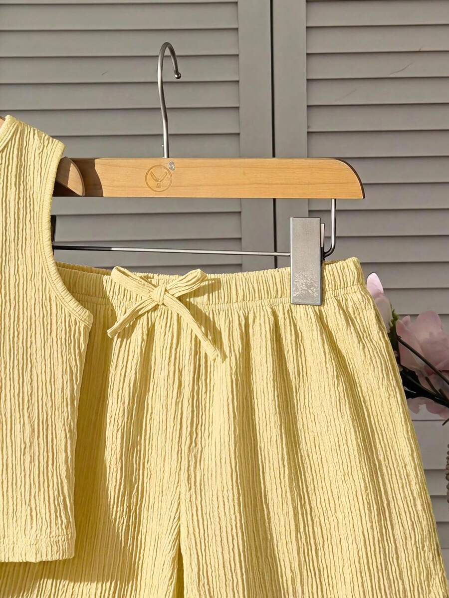 Tween girl 2-piece summer set with a black and white sleeveless striped spaghetti strap tank top with ruffle details and matching casual shorts.