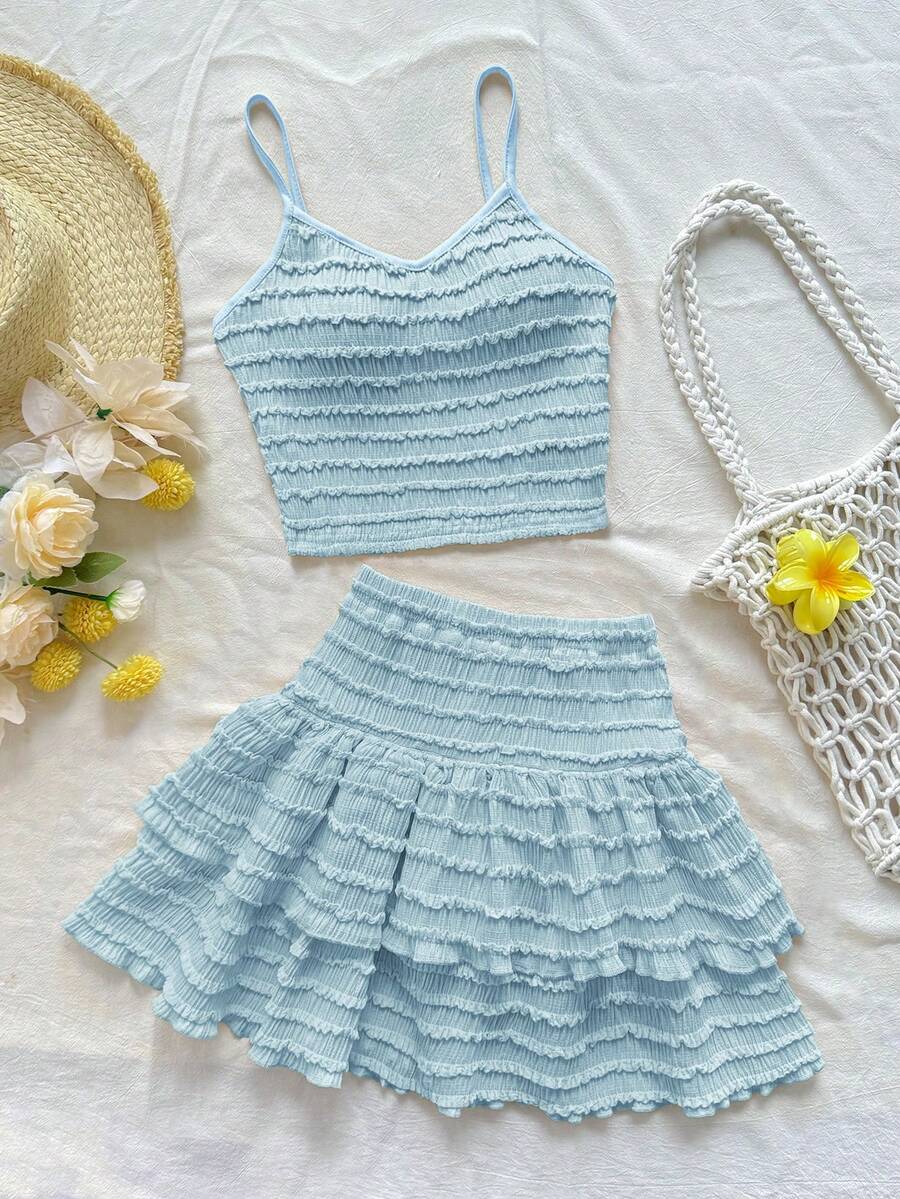 Tween girls solid color two-piece vacation outfit featuring a spaghetti strap camisole short top and a tiered skirt in soft knitted fabric.
