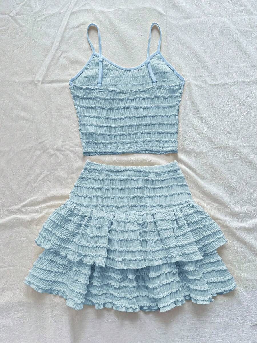 Tween girls solid color two-piece vacation outfit featuring a spaghetti strap camisole short top and a tiered skirt in soft knitted fabric.