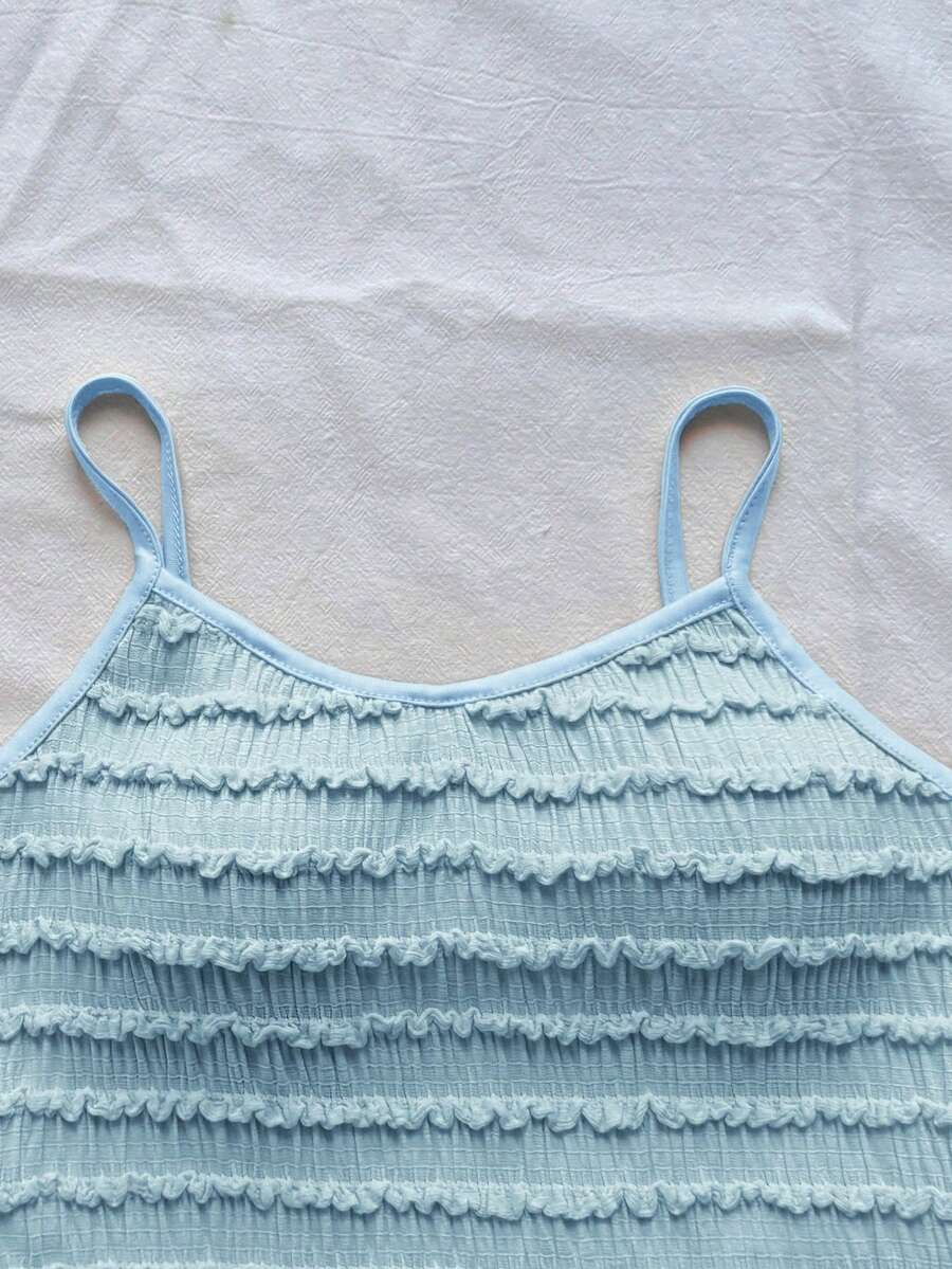 Tween girls solid color two-piece vacation outfit featuring a spaghetti strap camisole short top and a tiered skirt in soft knitted fabric.