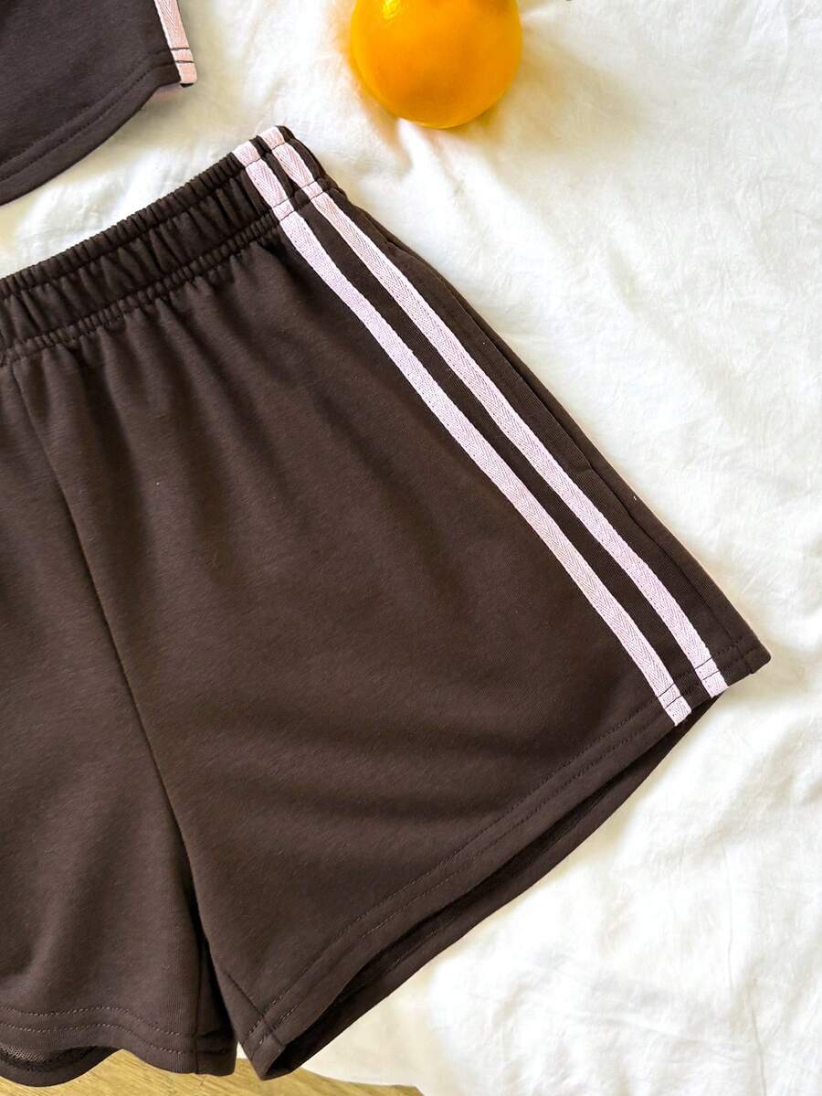 Tween girls two-piece summer outfit featuring a brown strapless tube top with contrast pink tape accent and matching brown shorts with pockets.