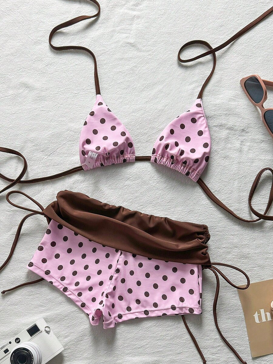 Women's halter triangle bikini top with knot detail paired with mid-waist colorblock swim shorts.