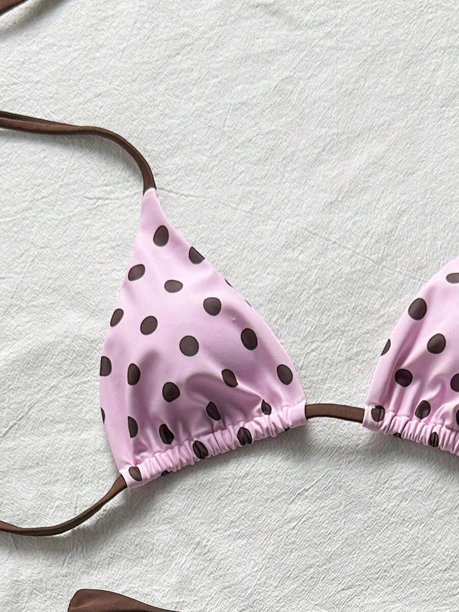 Women's halter triangle bikini top with knot detail paired with mid-waist colorblock swim shorts.