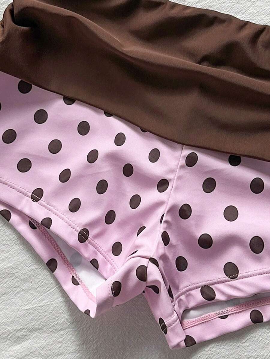 Women's halter triangle bikini top with knot detail paired with mid-waist colorblock swim shorts.