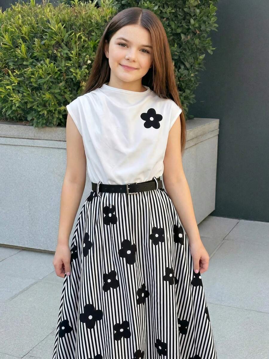 Tween girl wearing an apricot plant print sleeveless A-line long dress with a round neckline and flared skirt.