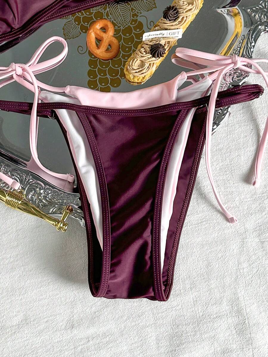 Women's retro polka dot high waist bikini swimsuit set with spaghetti straps and knot tie-back top.