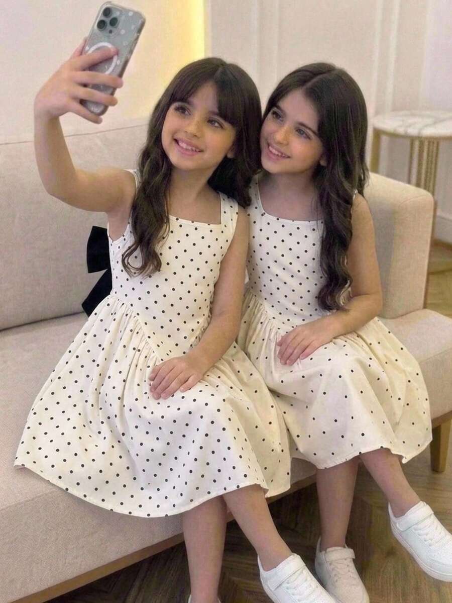 Black and white polka dot sleeveless A-line dress for tween girls featuring a scoop neck, high waist, and flared hem.