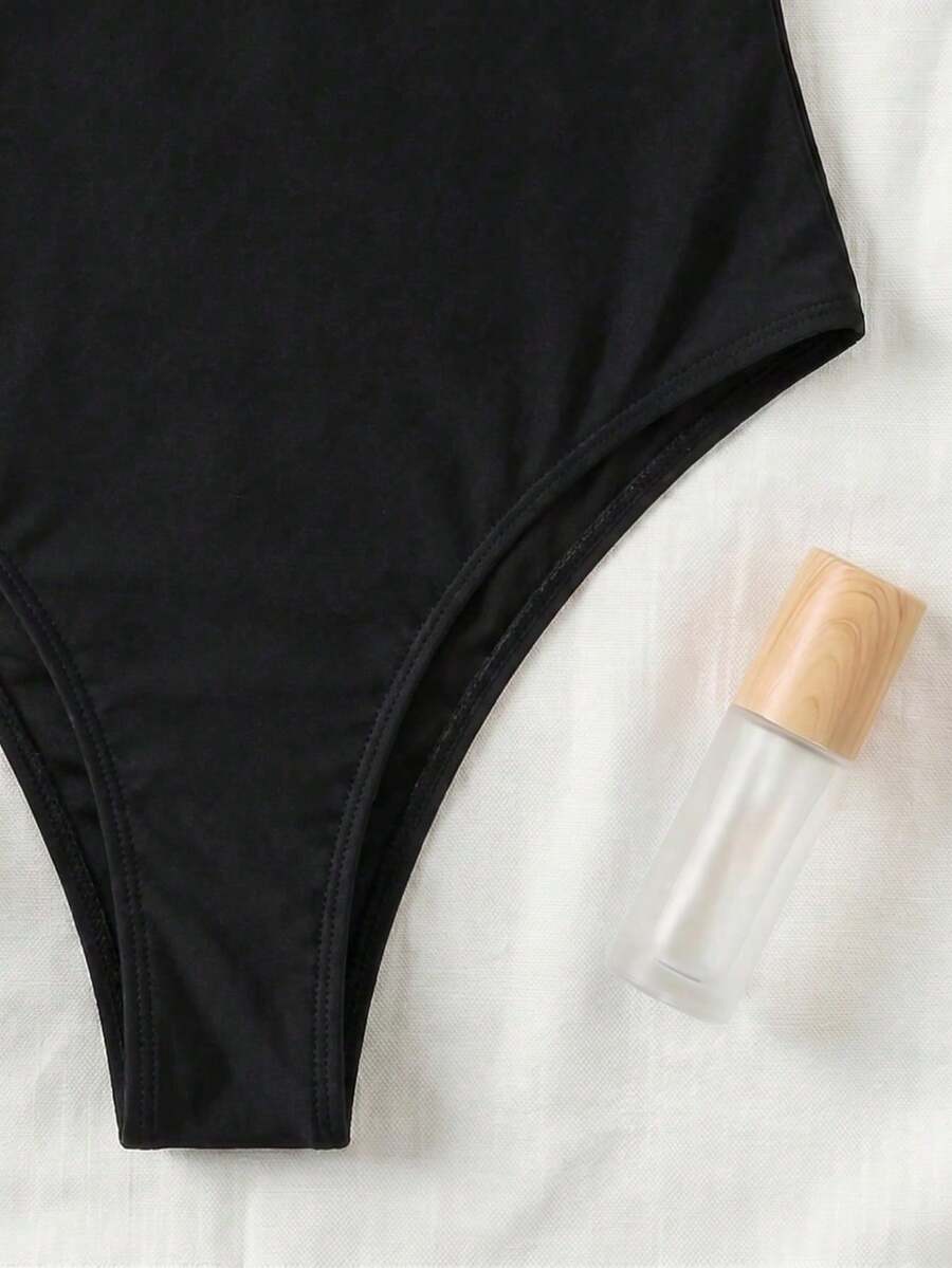 Black colorblock women's one-piece swimsuit with spaghetti straps and high stretch fabric.