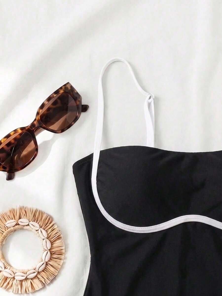 Black colorblock women's one-piece swimsuit with spaghetti straps and high stretch fabric.