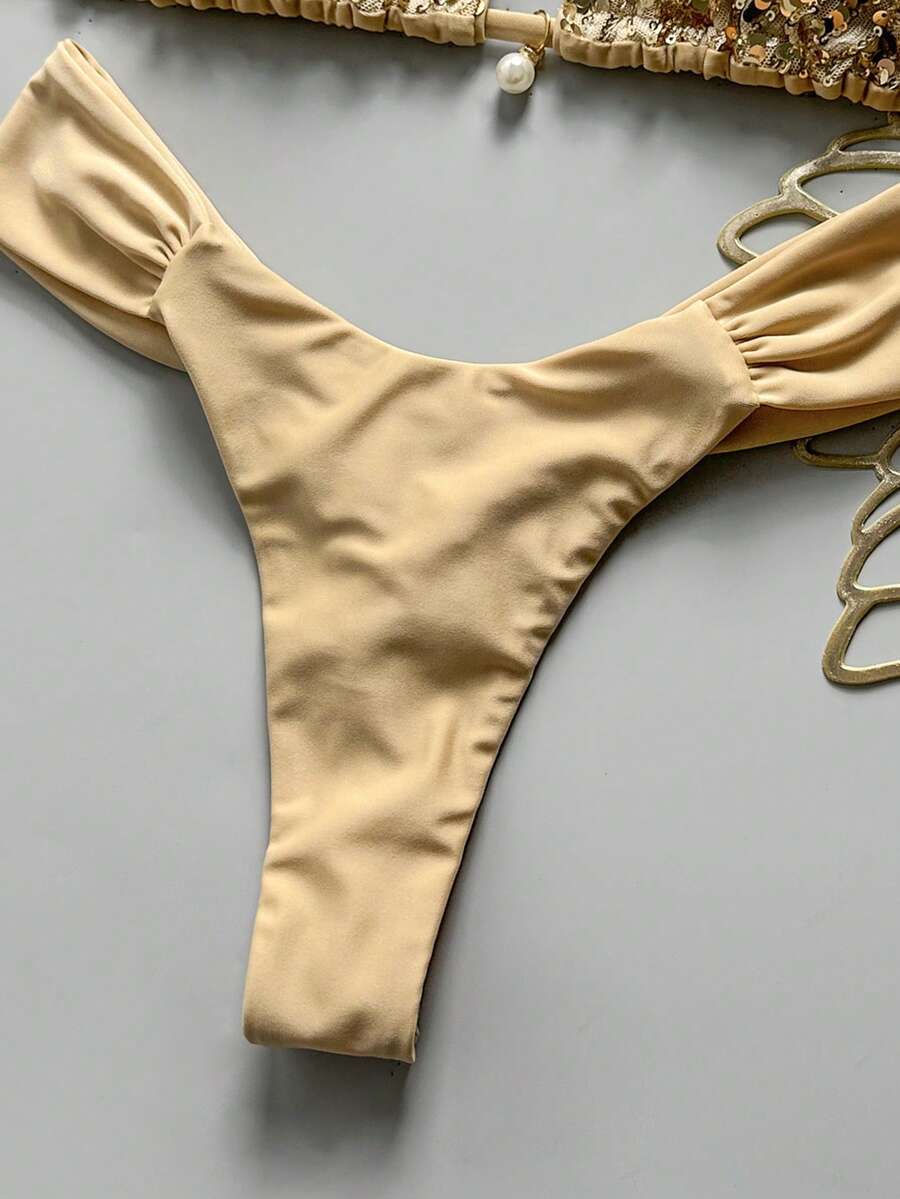 Women's 2-piece triangle cup bikini set in solid color featuring woven pearl shell decoration, halter neckline, and high-waist side-tie ruched bottoms.