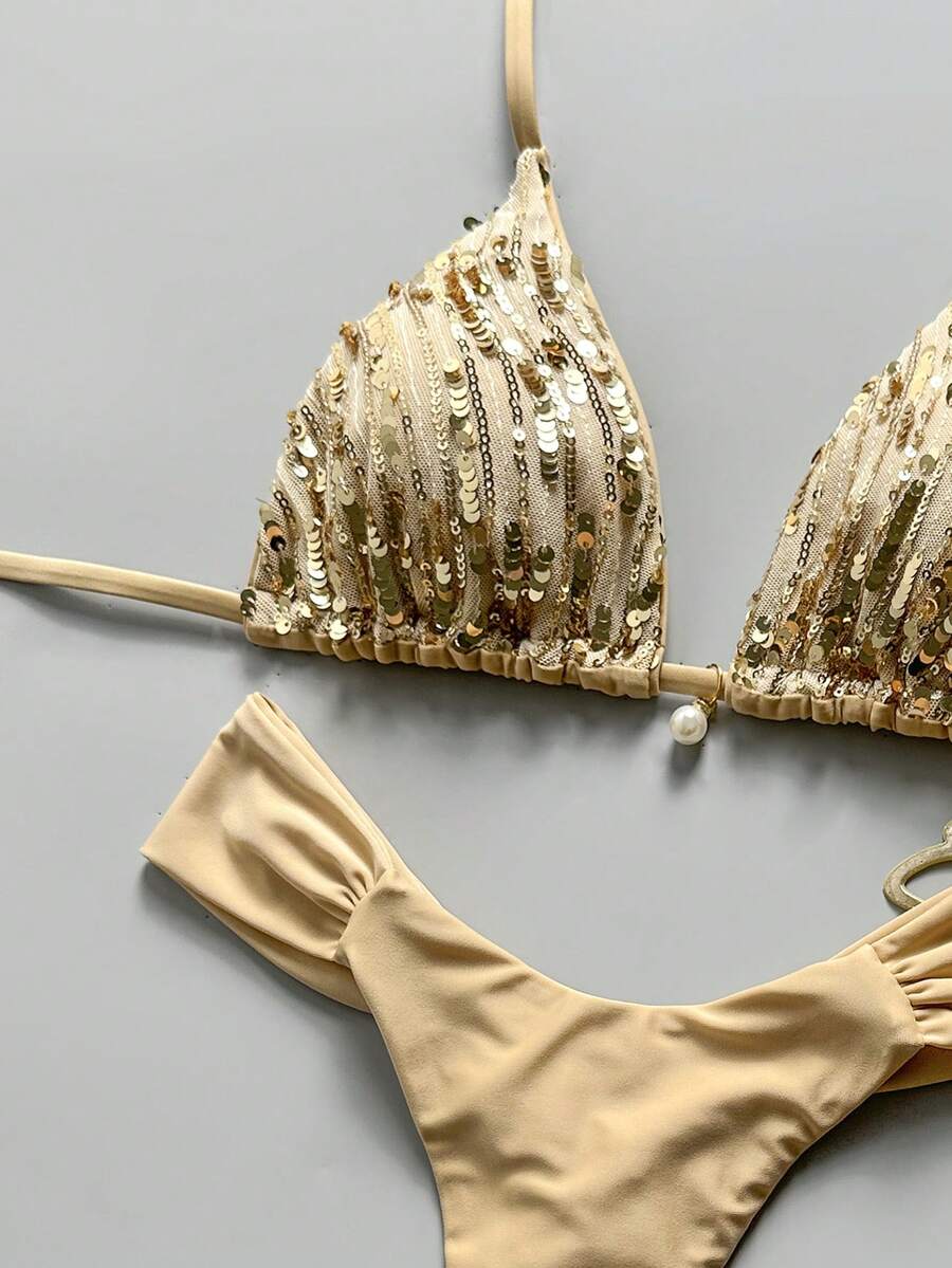 Women's 2-piece triangle cup bikini set in solid color featuring woven pearl shell decoration, halter neckline, and high-waist side-tie ruched bottoms.