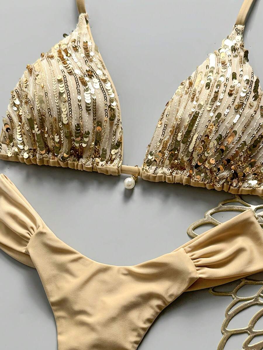 Women's 2-piece triangle cup bikini set in solid color featuring woven pearl shell decoration, halter neckline, and high-waist side-tie ruched bottoms.