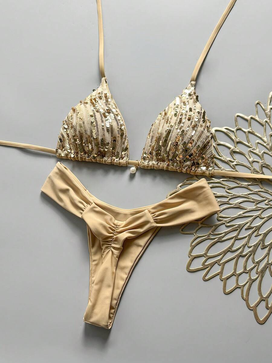 Women's 2-piece triangle cup bikini set in solid color featuring woven pearl shell decoration, halter neckline, and high-waist side-tie ruched bottoms.