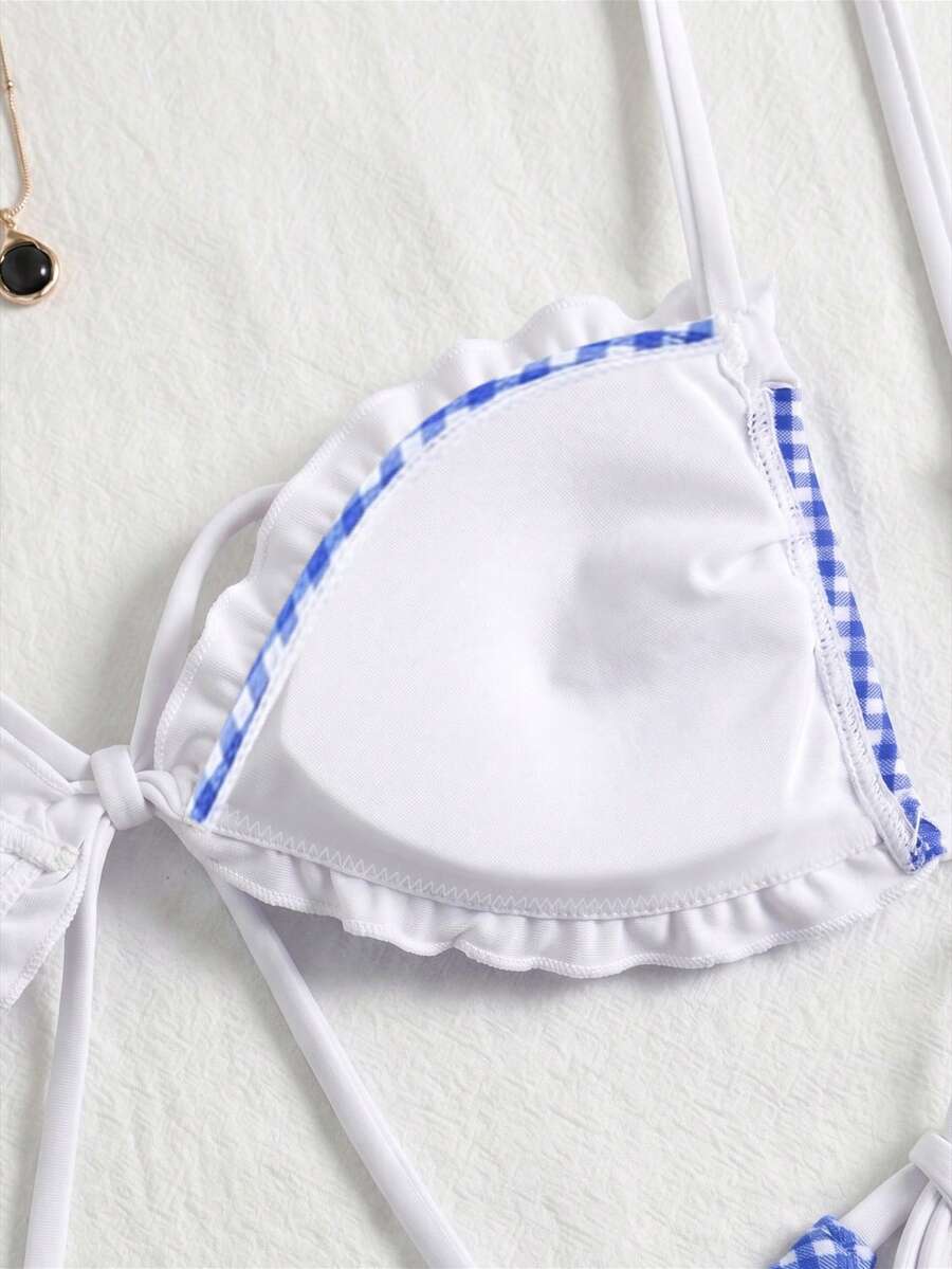 Women's beige two-piece bikini set featuring a wireless top with removable padding, spaghetti straps, tie back detail, and low waist hipster swimsuit bottoms.