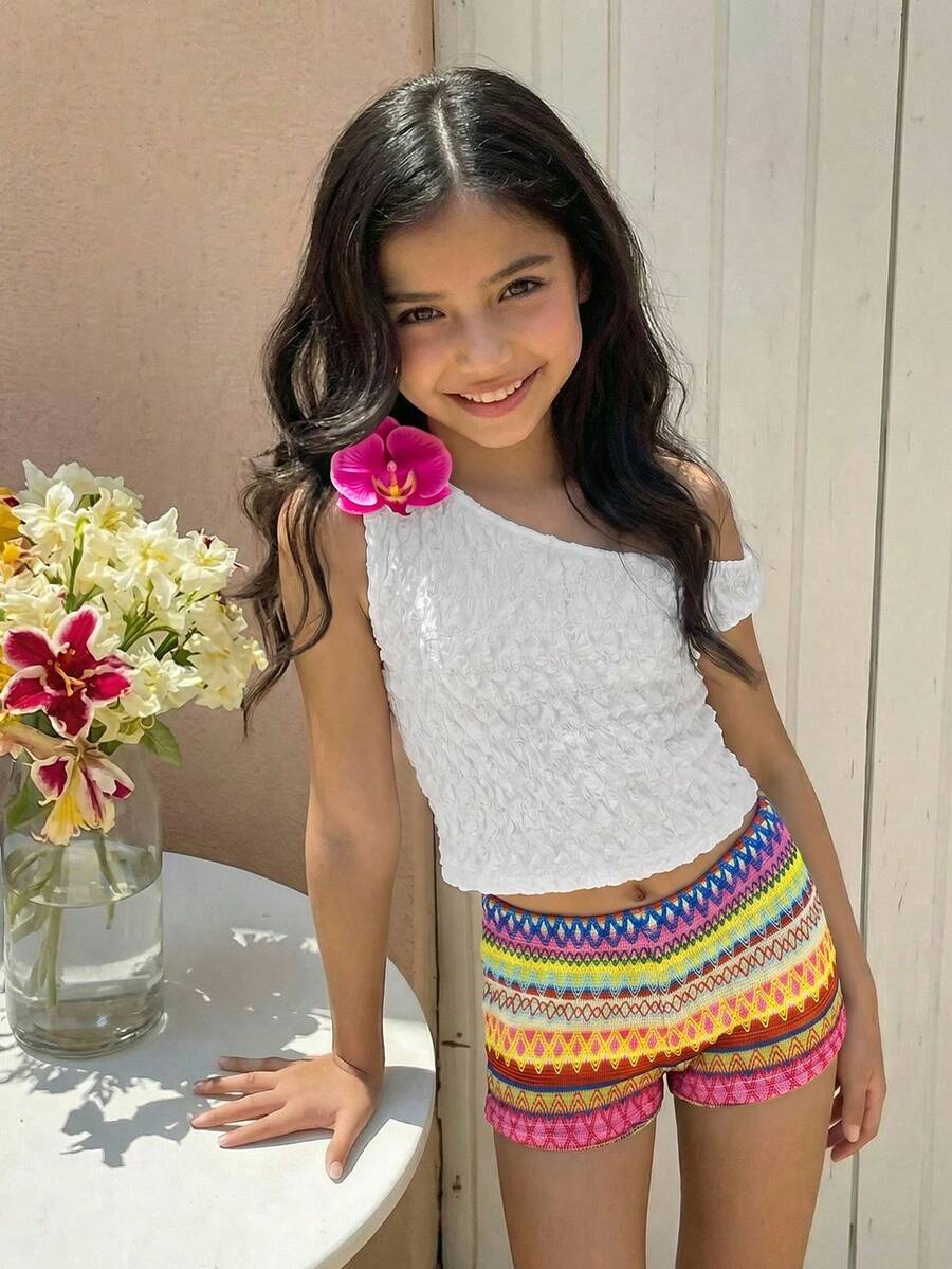 Tween girls 2-piece summer clothing set featuring a black asymmetric rib-knit striped off-shoulder t-shirt and matching slim fit shorts.